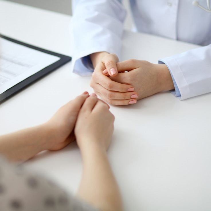 Doctor and patient are discussing something, just hands at the table